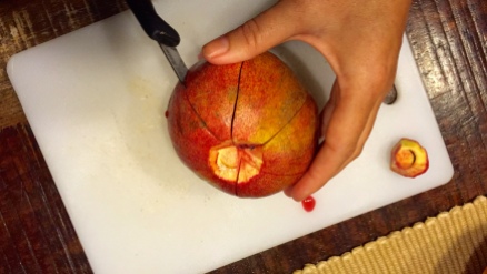 Make shallow slice all around the outer part of the pomegranate, from belly button to base.